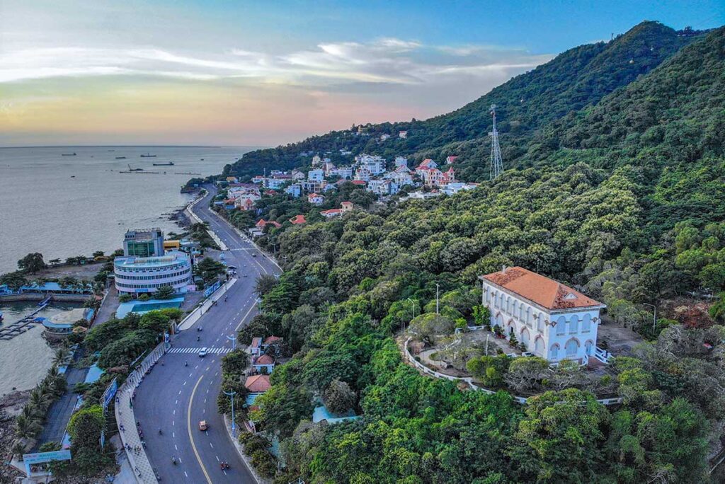 Aerial view of White Palace (Bach Ding Palace) in Vung Tau with the coastal road below