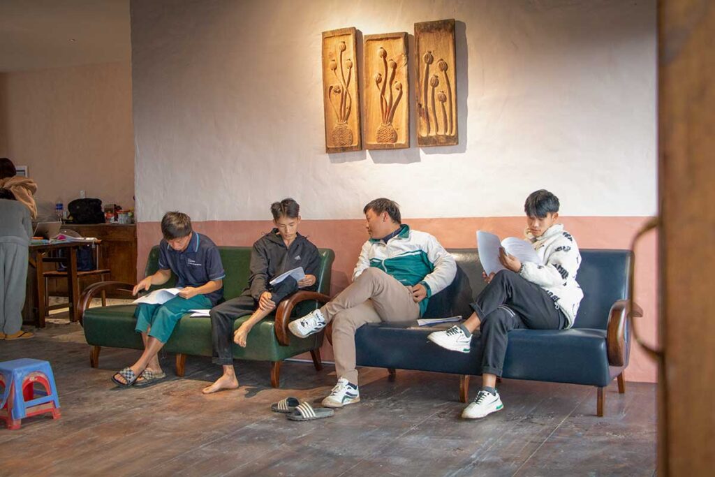 Local Hmong team members from Ha Giang reviewing training materials inside the new Aya Lodge as part of Local Vietnam’s staff onboarding process.