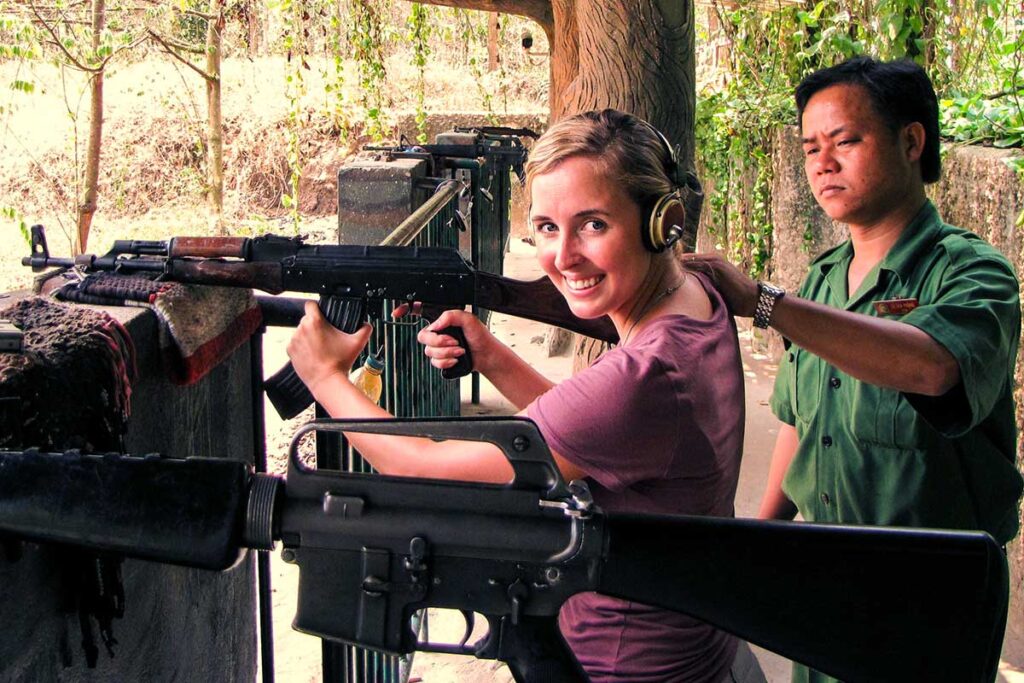 A backpacker in Vietnam holding a AK47 at the shooting range of the Cu Chi Tunnels near Ho Chi Minh City