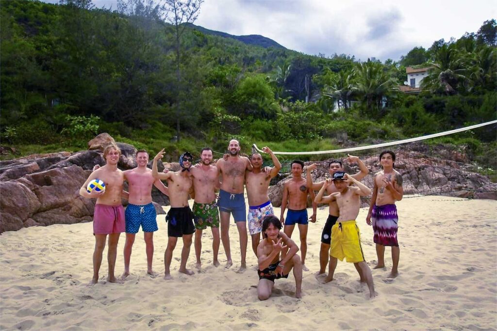 A group of backpackers playing volleyball on the beach of Bai Xep in Quy Nhon