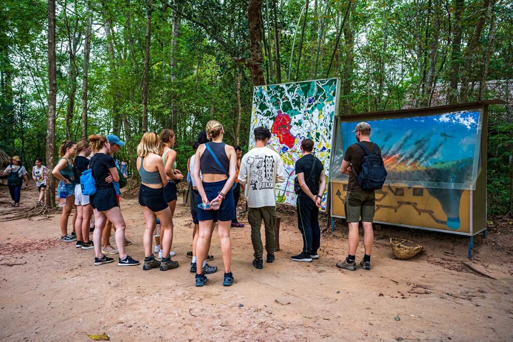 A group of backpackers at the Cu Chi Tunnels part of a group tour from Ho Chi Minh City