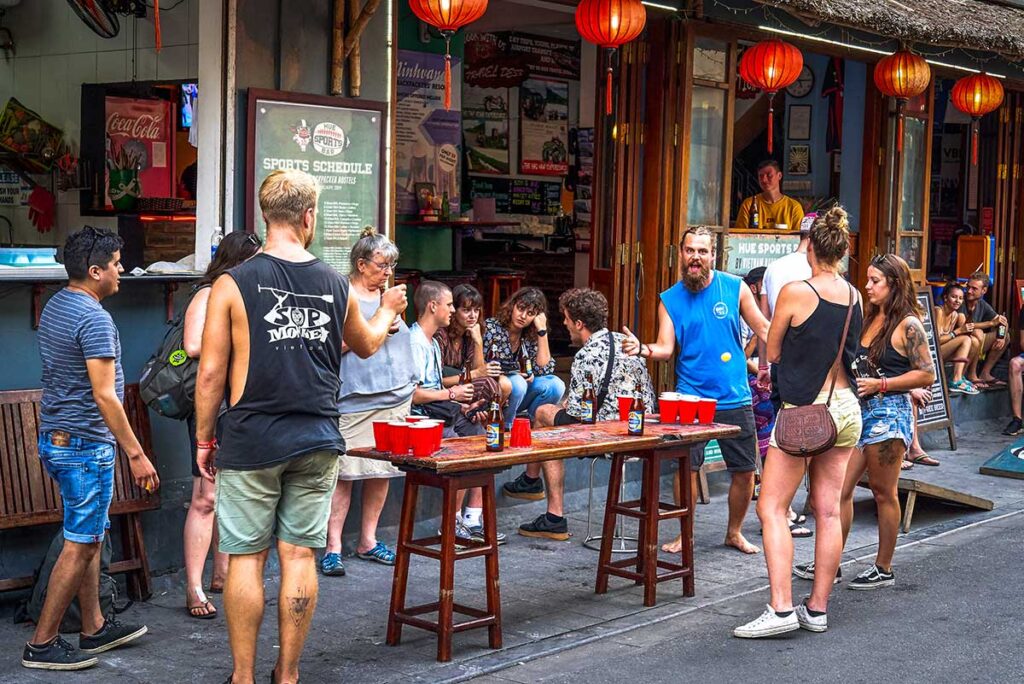 Backpackers in Vietnam playing beer pong on the street infront of their hostel