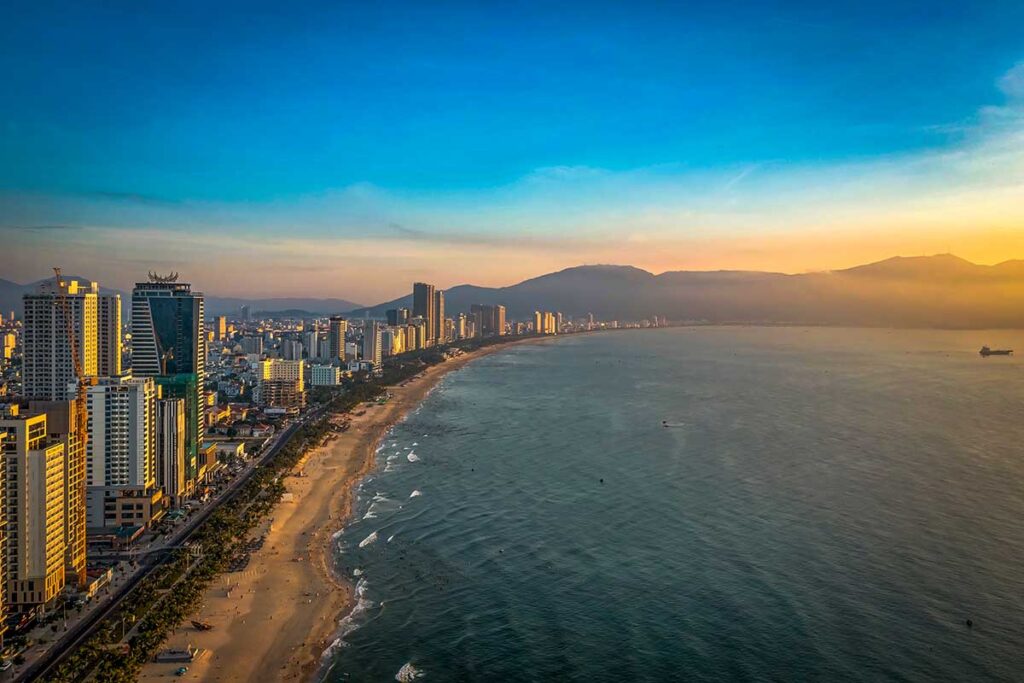 Da Nang Aerial View: An aerial view of Da Nang city showcases its long, sandy beach lined with modern high-rise hotels and resorts.