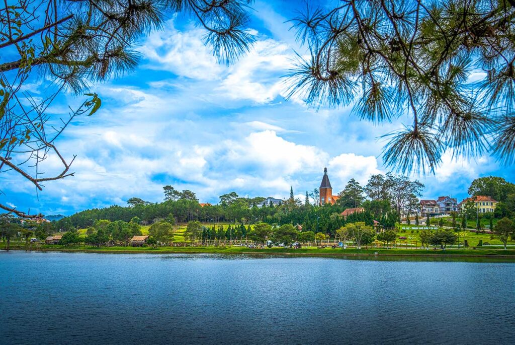 Dalat Cityscape with Lake: The tranquil Xuan Huong Lake reflects the charming architecture of Dalat city center, surrounded by lush greenery.