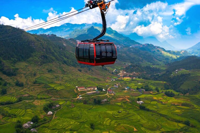 A cable car floating over the rice fields below of Muong Hoa Valley near Sapa on its way to the top of Fansipan Mountain