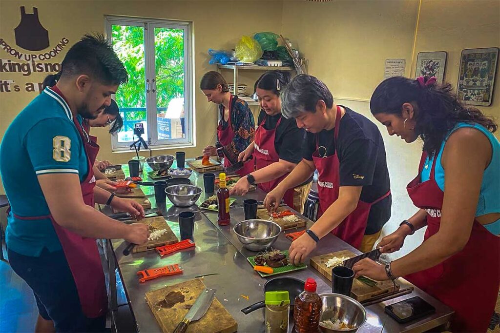 Hanoi Apron Up Cooking Class: Participants engage in a fun and interactive cooking class at Hanoi Apron Up, mastering the art of Vietnamese cuisine. (unique dining in Hanoi)