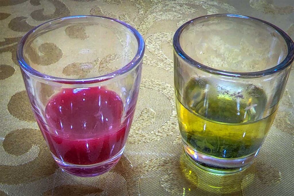 Two glasses of Snake Wine, at Hung Ha Noi Snake Restaurant in Le Mat Village.