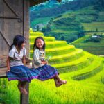 kids in Sapa sitting at a house overlooking stunning terraced rice fields
