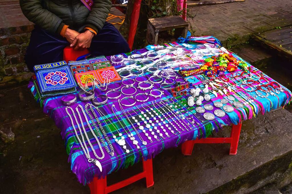 ethnic person selling silver jewelry on the streets of Sapa