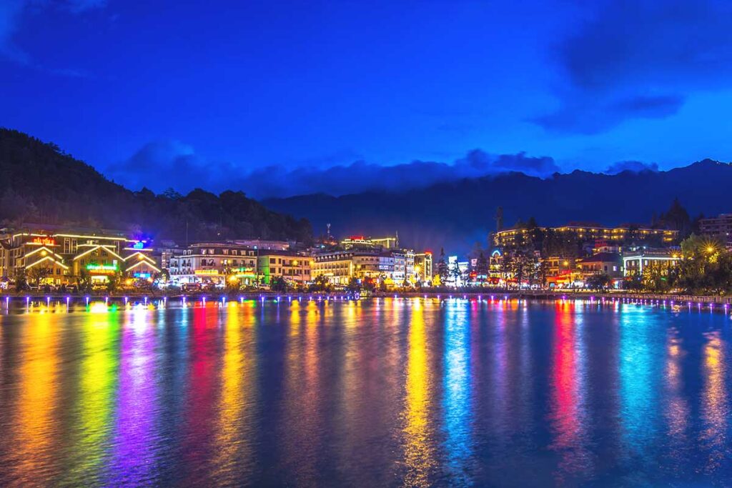 Sapa lake at night with lights reflecting on the water