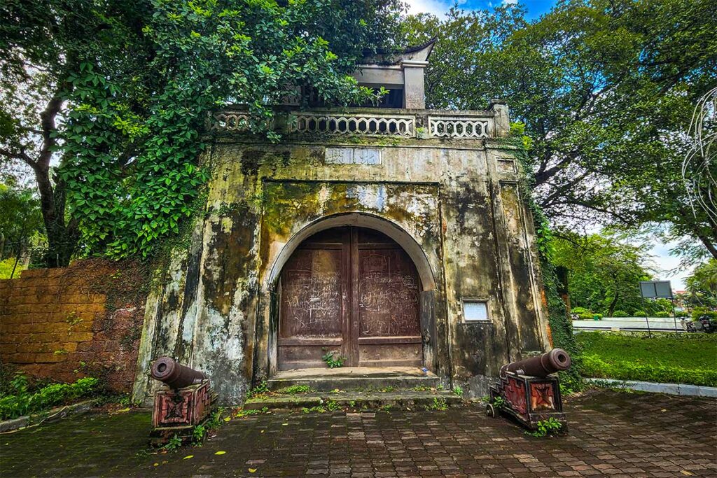 Son Tay Old Fortress Gate with Cannons: A fortified gate at Son Tay Old Fortress, guarded by two imposing cannons.