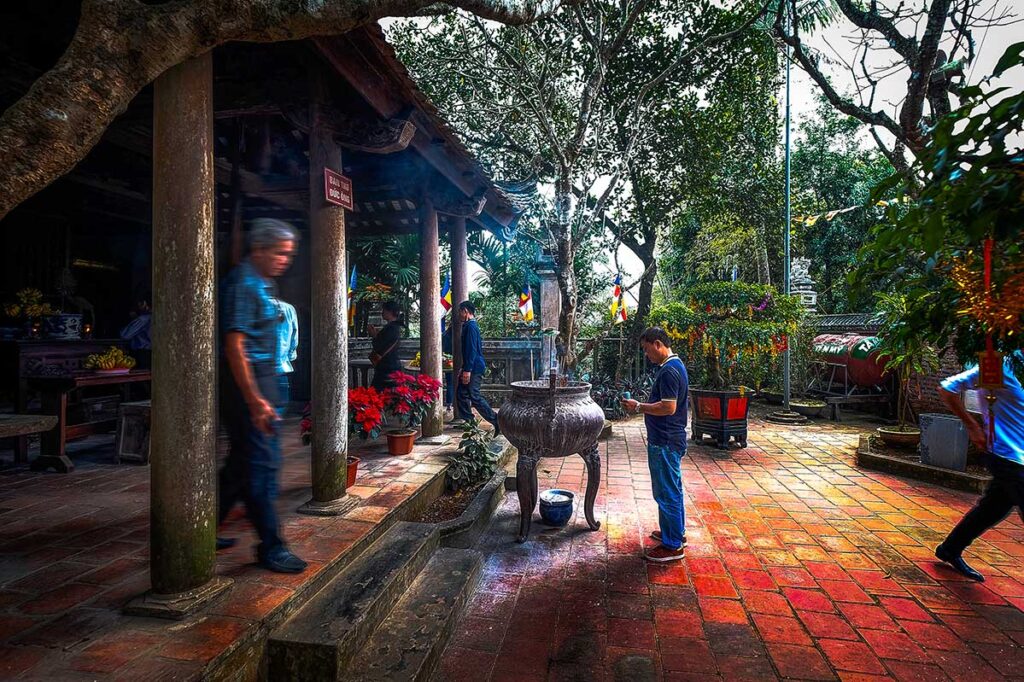 Worshippers at Tay Phuong Pagoda: Devotees offer prayers at the serene Tay Phuong Pagoda, a hidden gem near Hanoi, Vietnam.