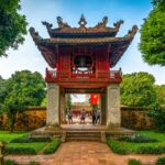 Temple of Literature Gate with Roof: The beautifully tiled and carved roof of a gate at the Temple of Literature in Hanoi showcases intricate craftsmanship.