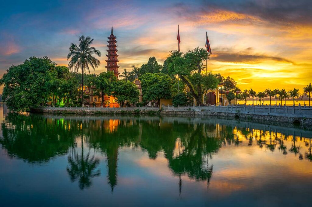 Tran Quoc Pagoda at Dawn: Golden sunlight bathes the Tran Quoc Pagoda in Hanoi at dawn, creating a magical scene for photographers. (best Instagram spots in Hanoi)