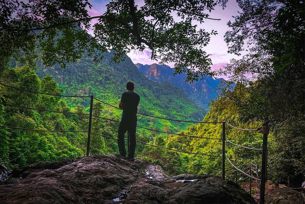 A man standing at a viewpoint at the Botanical Garden in Phong Nha