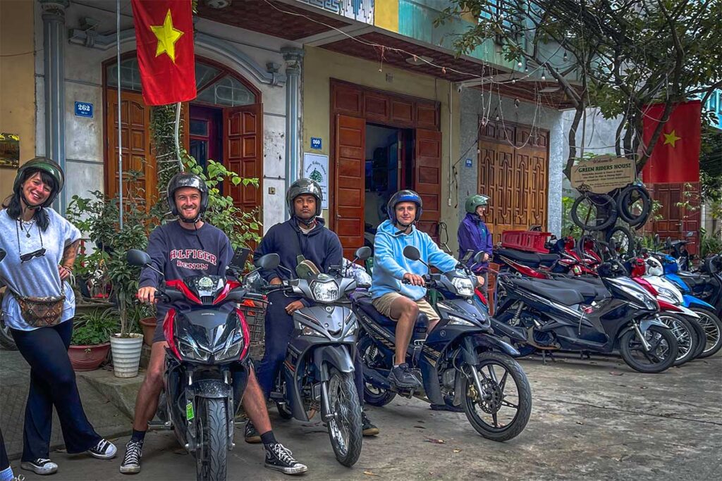 A group of foreign tourists sitting on their rented semi-automatic motorbike at a motorbike rental in Cao Bang