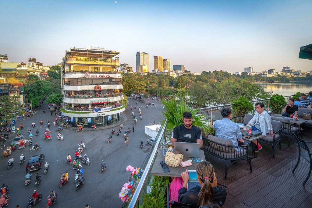 A view from a coffee shop at Dong Kinh Nghia Thuc Square in the Old Quarter of Hanoi while traffic is rushing by
