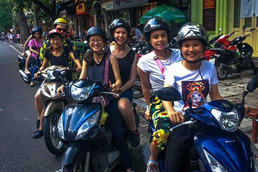 Tourists join a motorbike tour in Hanoi