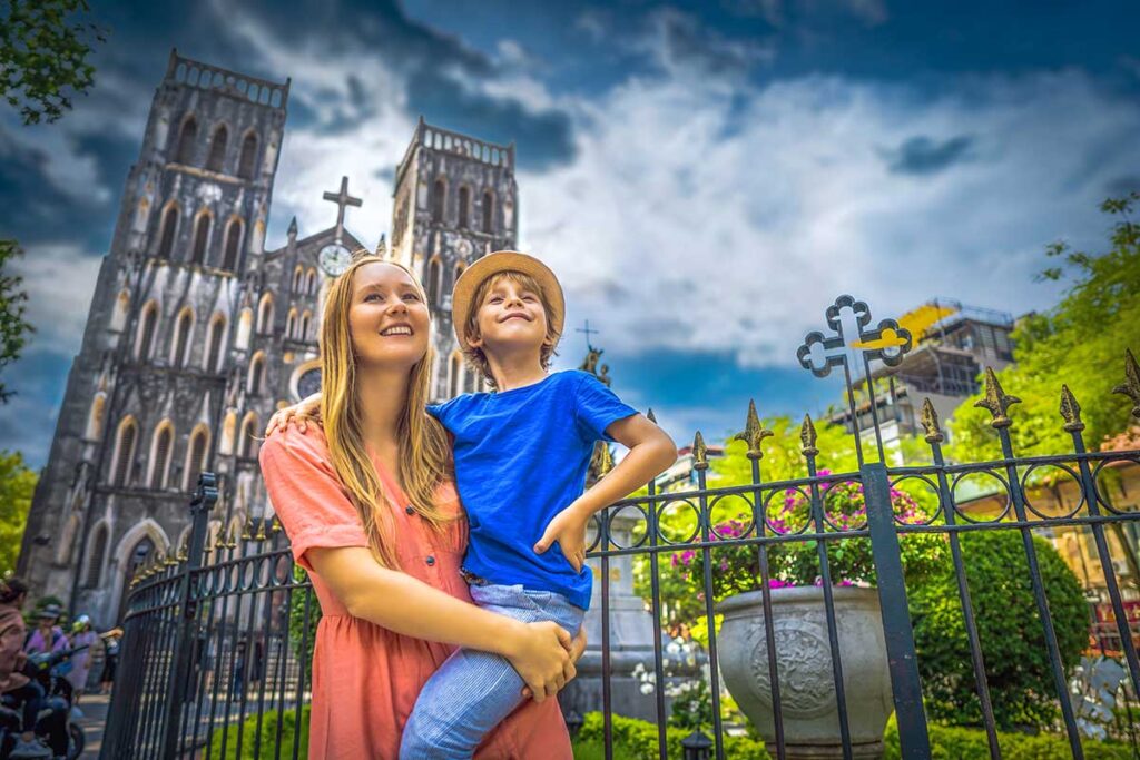 A mother and son standing in front of the st Joseph Cathedral in the Old Quarter, a great thing to do in Hanoi with kids