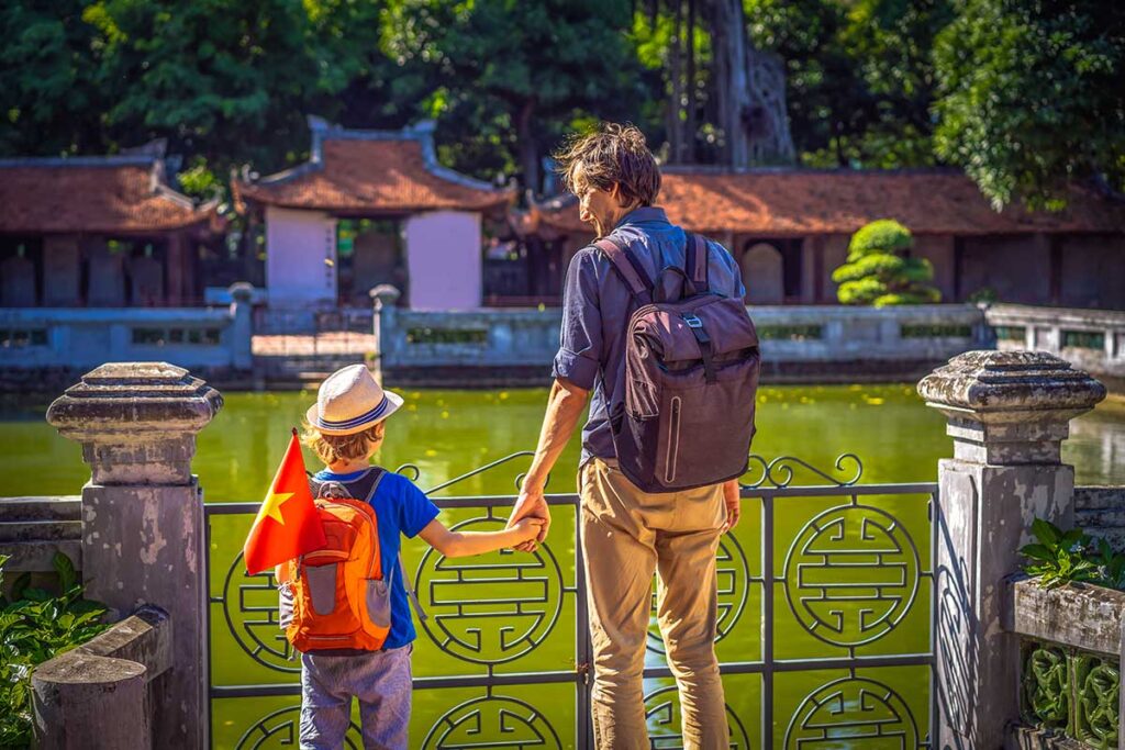 A farther and son standing in the Temple of Literature - a great things to do in Hanoi with kids