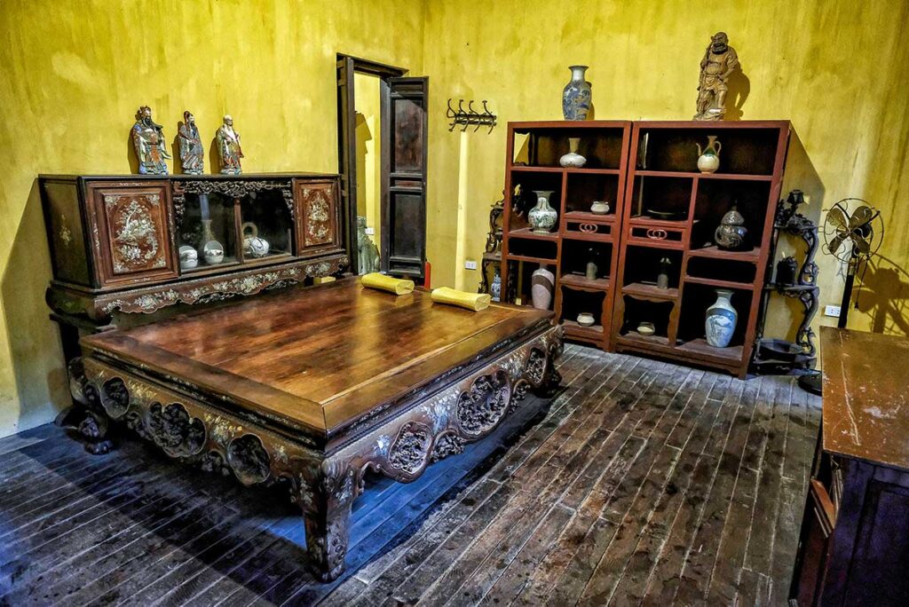 Traditional bed in one of the bedrooms inside 87 Ma May street old house