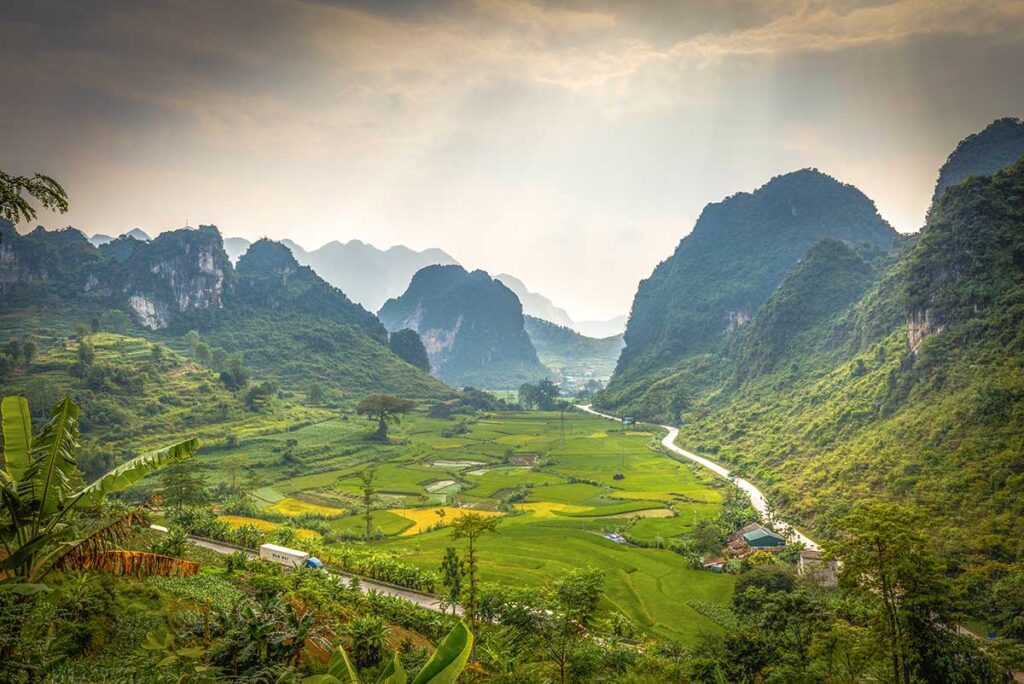 The view from Ma Phuc Pass in Cao Bang, with a green valley full of rice fields