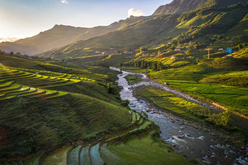 river running through Muong Hoa Valley with rice fields on both sides