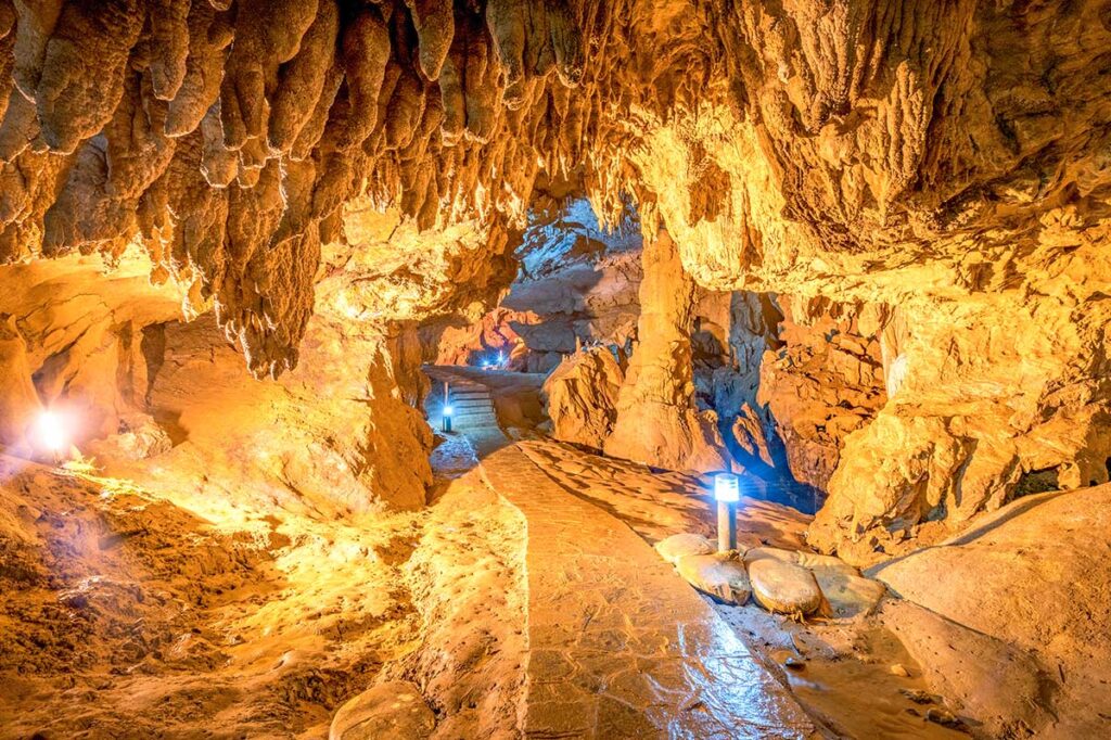 A path with lights going through the Nguom Ngao Cave