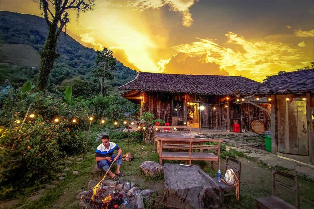 A man sitting at a campfire at a local homestay near Phia Oac National Park