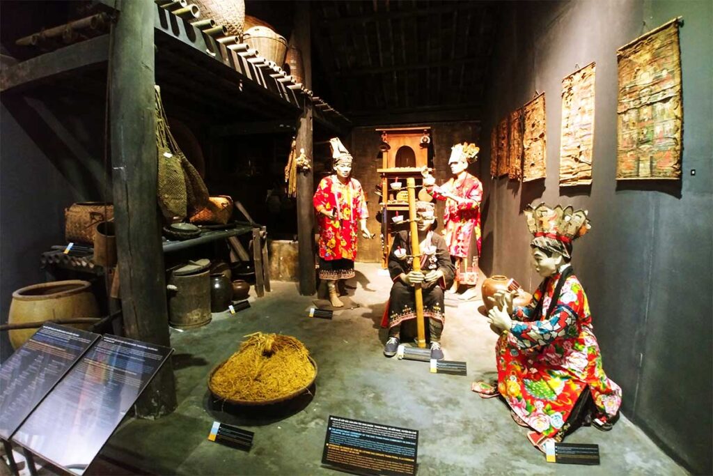 Display of ethnic minority dolls in traditional living setting within Quang Ninh Museum