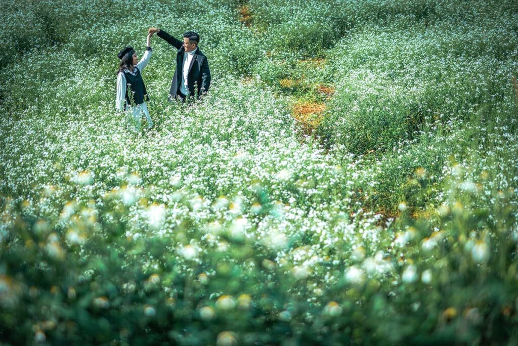 Romantic couple playful in the flower fields of Dalat