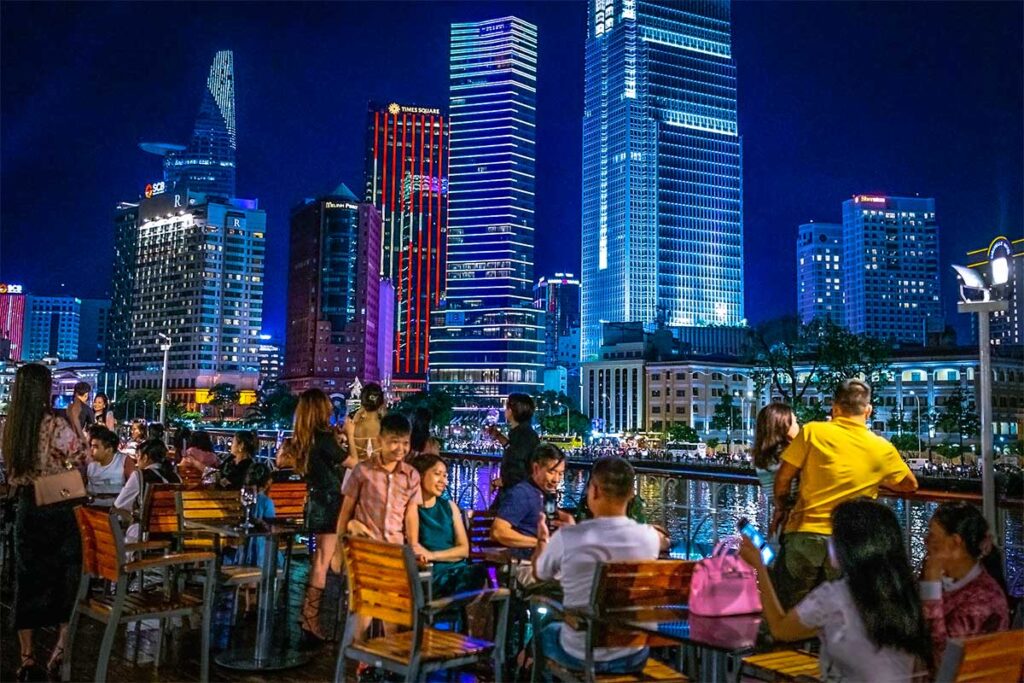 People enjoying the skyline of Ho Chi Minh City from a dinner cruise on the Saigon River