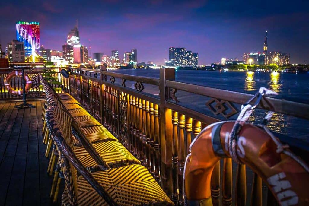 Dinner cruise at night over the Saigon River with the skyline of Ho Chi Minh City
