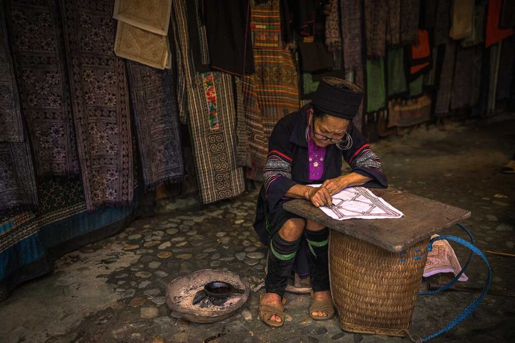 A local Hmong woman in Sapa is making batik