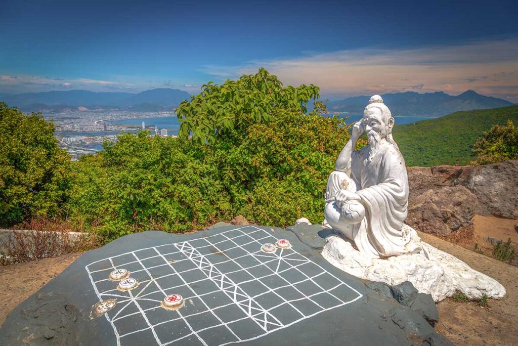 A statue of Confucius playing chess at Ban Co Peak on Son Tra Peninsula, symbolizing local legends.