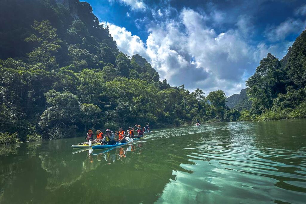 A group of people supping on Thang Hen Lake