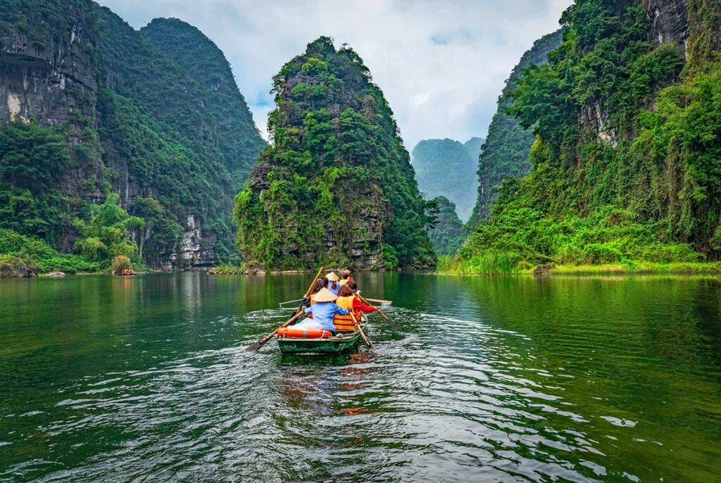 A rowing boat tour through Trang An Scenic Landscape Complex with views of Vietnam's amazing mountain scenery