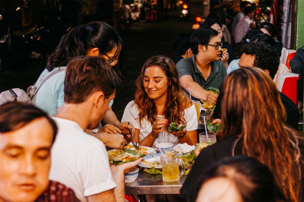 Tourists enjoying a vegan food tour in Ho Chi Minh City