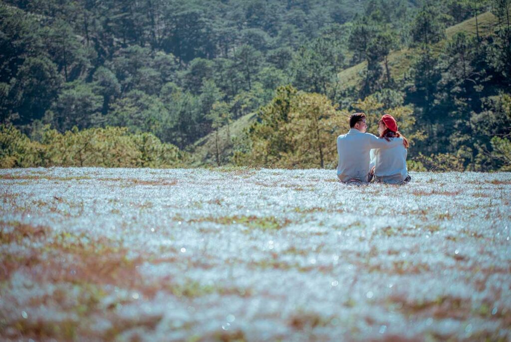Couple sitting together in the countryside near Dalat, a popular romantic getaway in Vietnam.