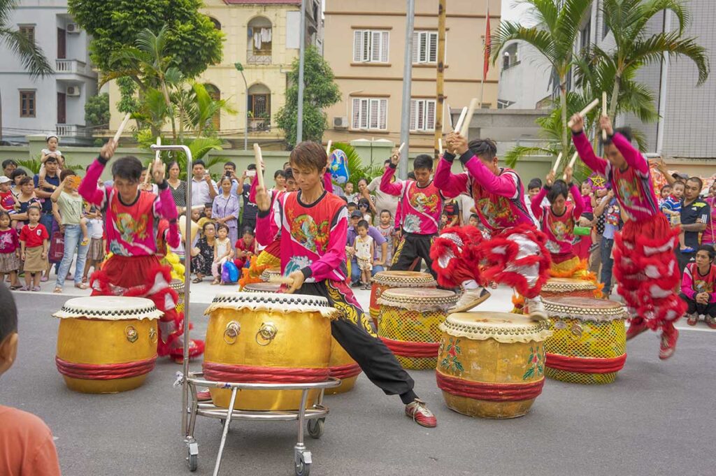 Traditional drum performance accompanying a Vietnamese lion dance during a public celebration.