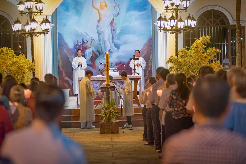 Easter church service in Vietnam with local worshippers attending mass inside a Catholic church.