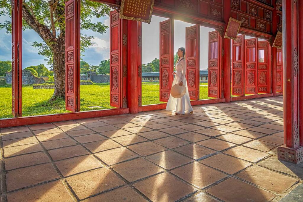 Woman walking through the Imperial City in Hue, a peaceful and romantic cultural site in central Vietnam.