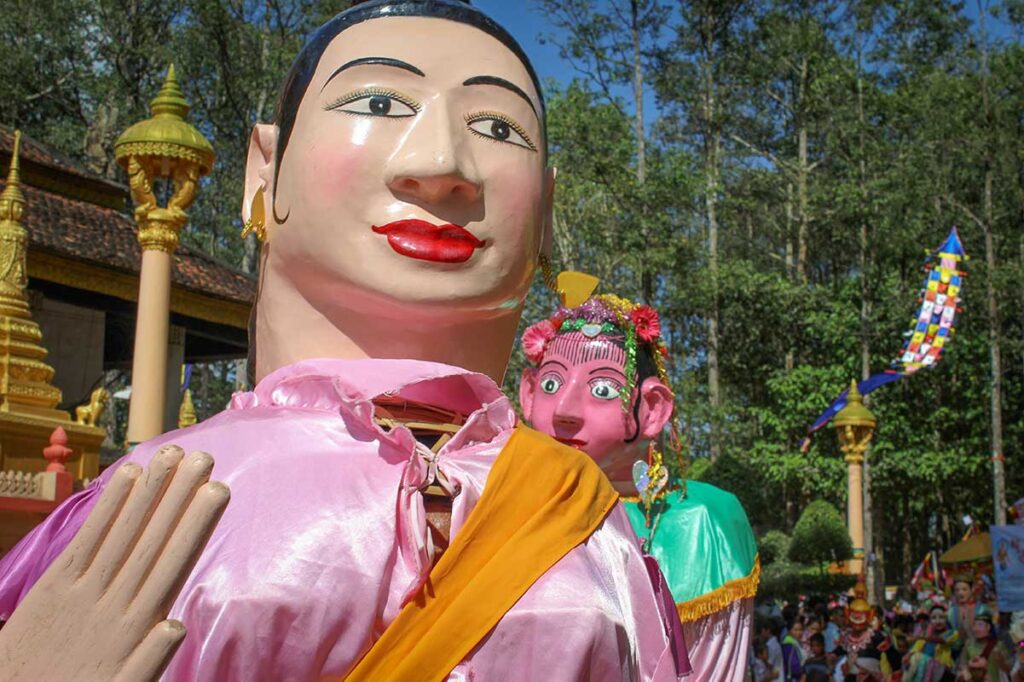 Kathina Ceremony in Vietnam with giant Khmer festival figures used in robe-offering processions.