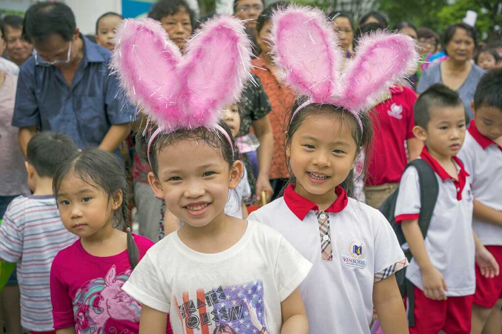 Vietnamese children wearing bunny ears during Easter celebrations in Vietnam.