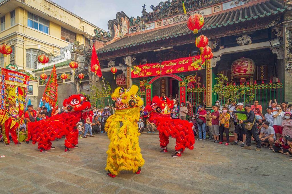 Lion dance performance at a Chinese temple in Ho Chi Minh City during a traditional festival.