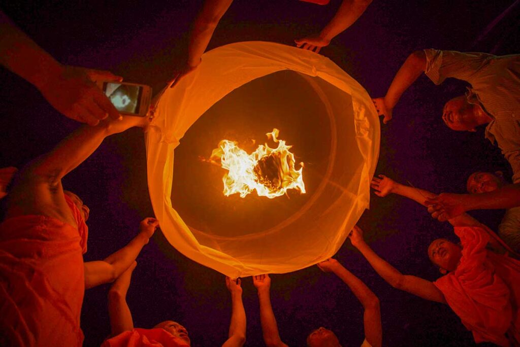 People releasing sky lanterns during the Ok Om Bok Festival in the Mekong Delta, a Khmer celebration in Tra Vinh with prayers for good harvest and prosperity.