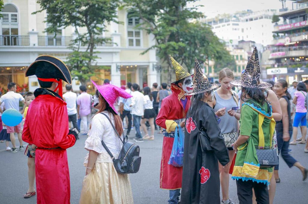People dressed in Halloween costumes gathering in Hanoi Old Quarter during Halloween celebrations.