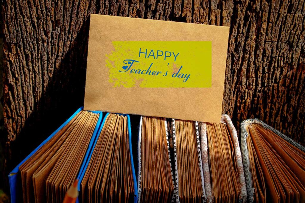 Vietnamese Teachers’ Day greeting card placed on school notebooks, symbolising respect for teachers in Vietnam.