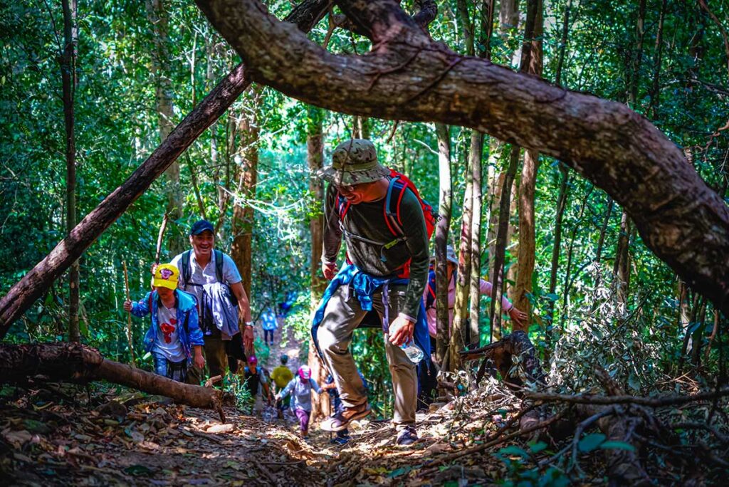 A group of Vietnamese tourists trekking in Bu Gia Map National Park