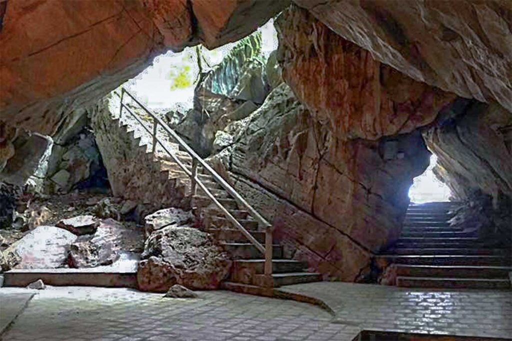 A cave from the inside with stairs leading out in Cam Mountain part of Ngu Dong Thi Son